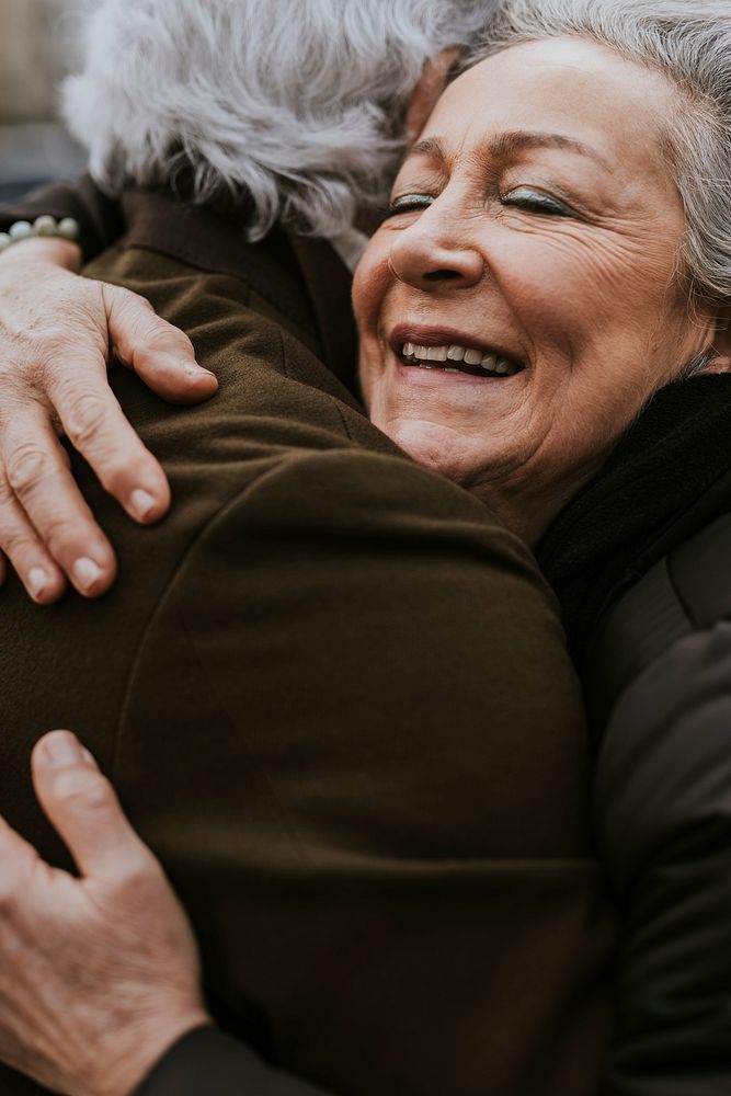 Senior couple hugging outdoors 