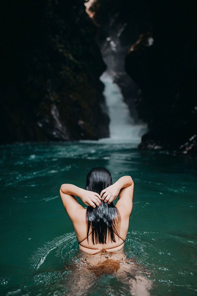 Woman at waterfall. Free public domain CC0 photo.