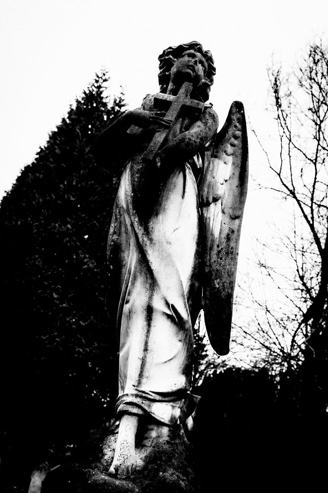 Archangel holding cross statue in cemetry. Original public domain image from Flickr