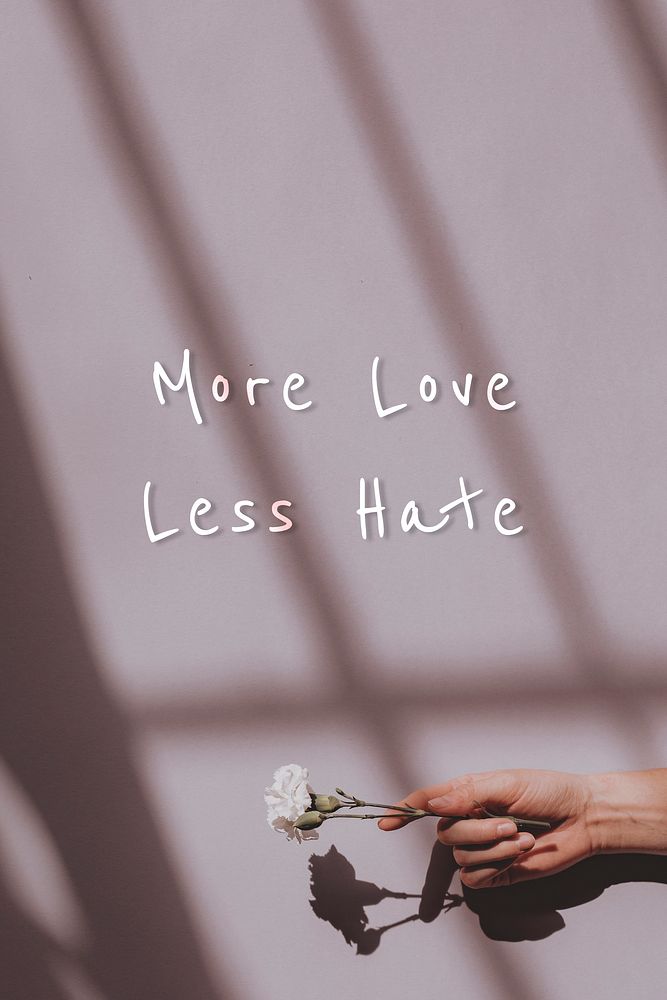 More love less hate quote on a hand holding flower background