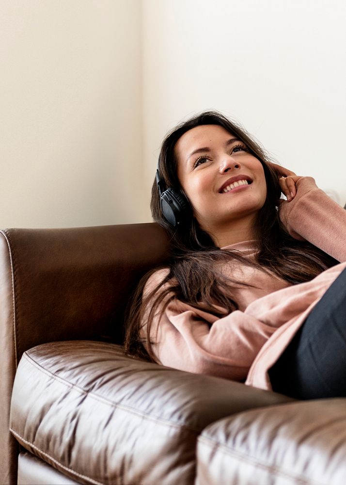 Girl listening to music on a couch 