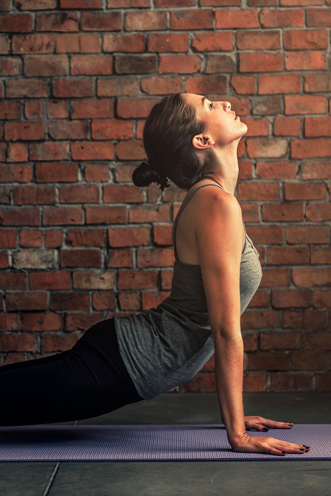 Woman stretching on a yoga mat 