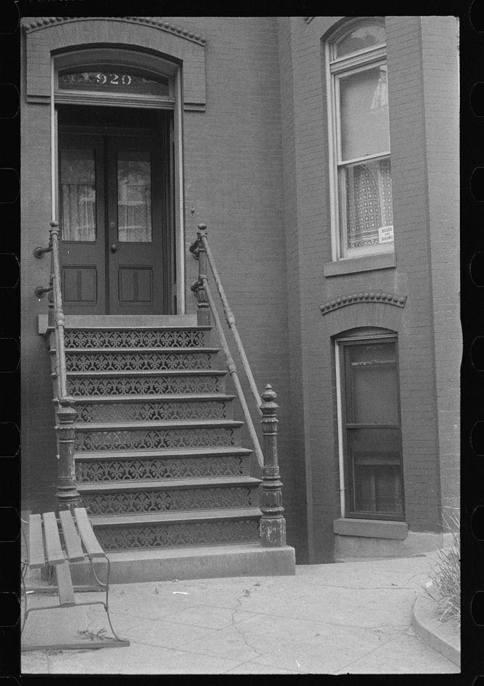Washington, D.C. The entrance to a rowhouse, showing a card in the window advertising rooms and board. Sourced from the…