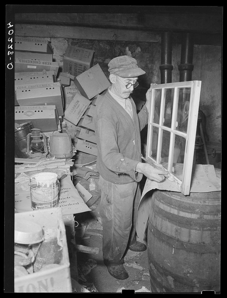 Lancaster County, Pennsylvania. One of the hired men on the Enos Royer farm painting a window sash for the chicken house. It…