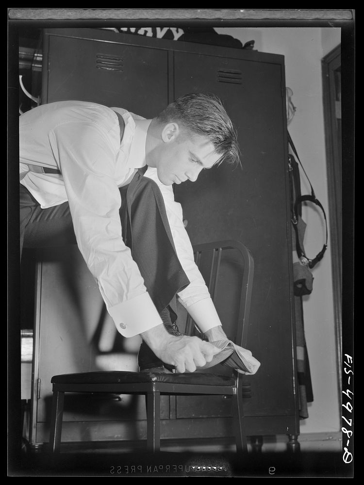 U.S. Naval Academy, Annapolis, Maryland. Midshipman polishing his shoes. Sourced from the Library of Congress.
