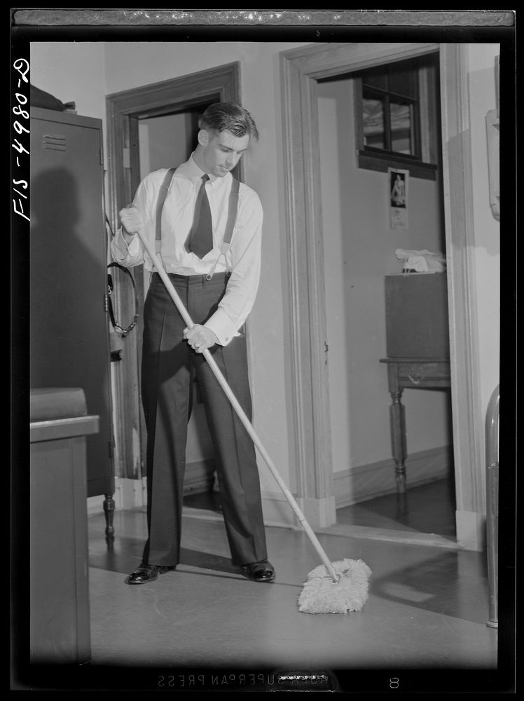 U.S. Naval Academy, Annapolis, Maryland. Midshipman cleaning the floor of his room. Sourced from the Library of Congress.