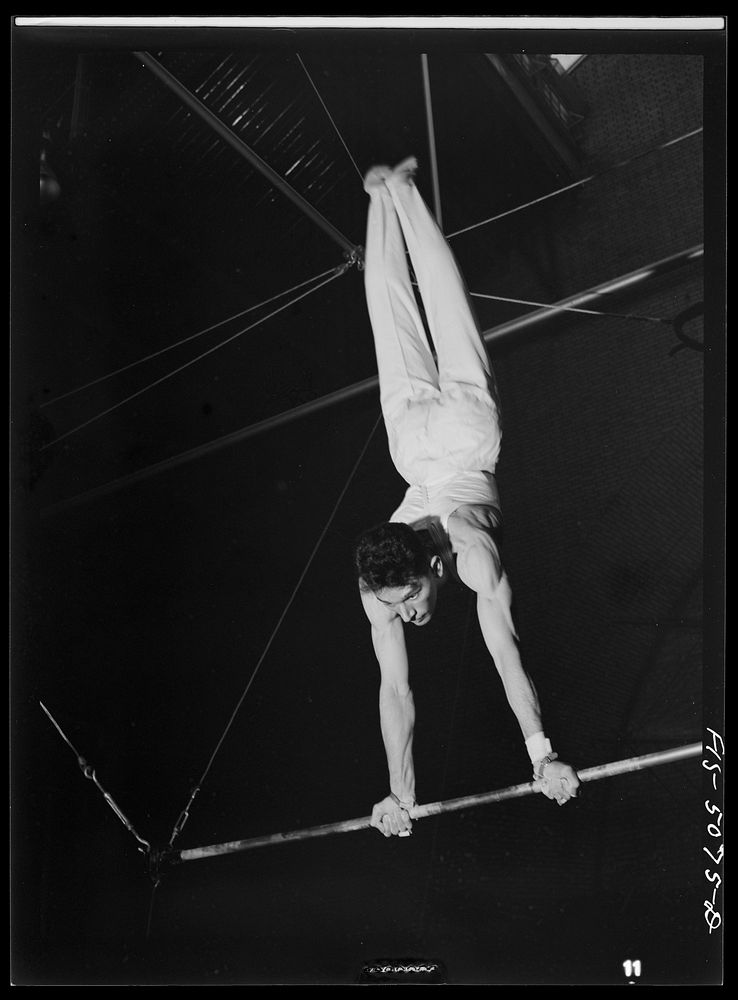 [Untitled photo, possibly related to: U.S. Naval Academy, Annapolis, Maryland. Gymnast on the flying rings]. Sourced from…