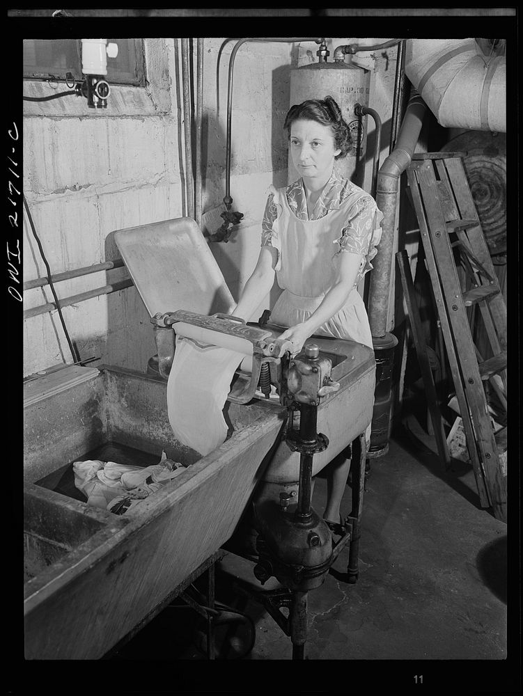 [Untitled photo, possibly related to: Rochester, New York. Mrs. Babcock doing the family washing with an electric washing…