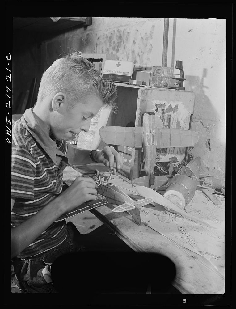 Rochester, New York. Howard Babcock hard at work on one of his model airplanes. Sourced from the Library of Congress.