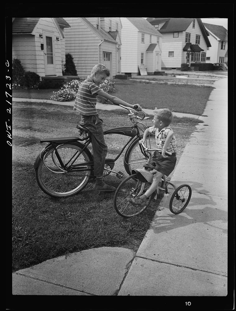 Rochester, New York. Howard and Earl Babcock playing in front of their house with their cycles. Sourced from the Library of…