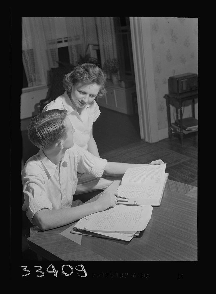 [Untitled photo, possibly related to: Keysville, Virginia. One of the teachers in the school helping her brother, a pupil…