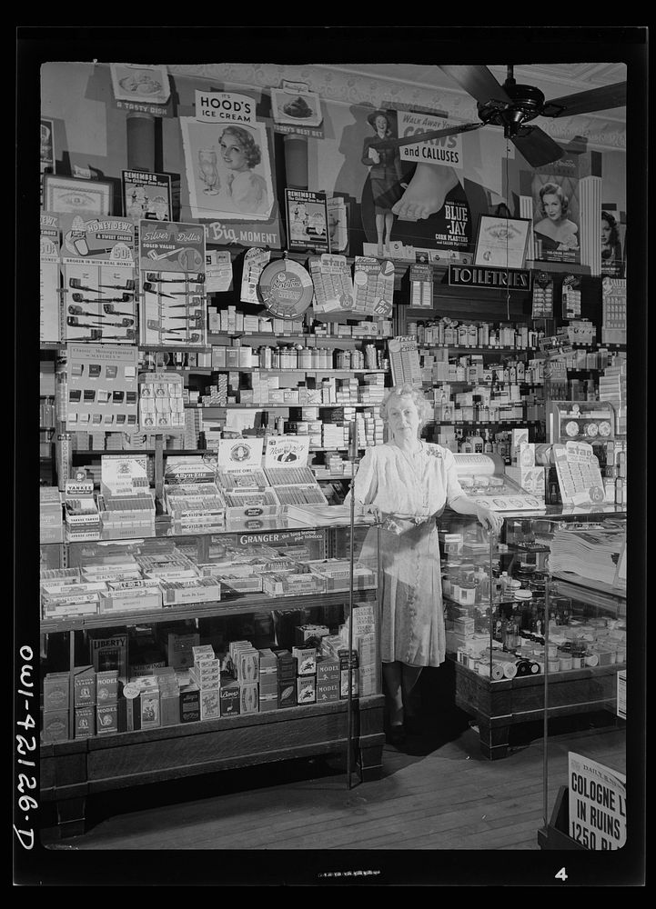 Southington, Connecticut. Mrs. Ethel Oxley, in the drugstore which she runs on the town's main street. Her family has had a…