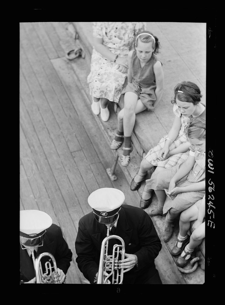 On board a Norwegian-American passenger liner enroute to New York. Children listening to the ship's orchestra. Sourced from…