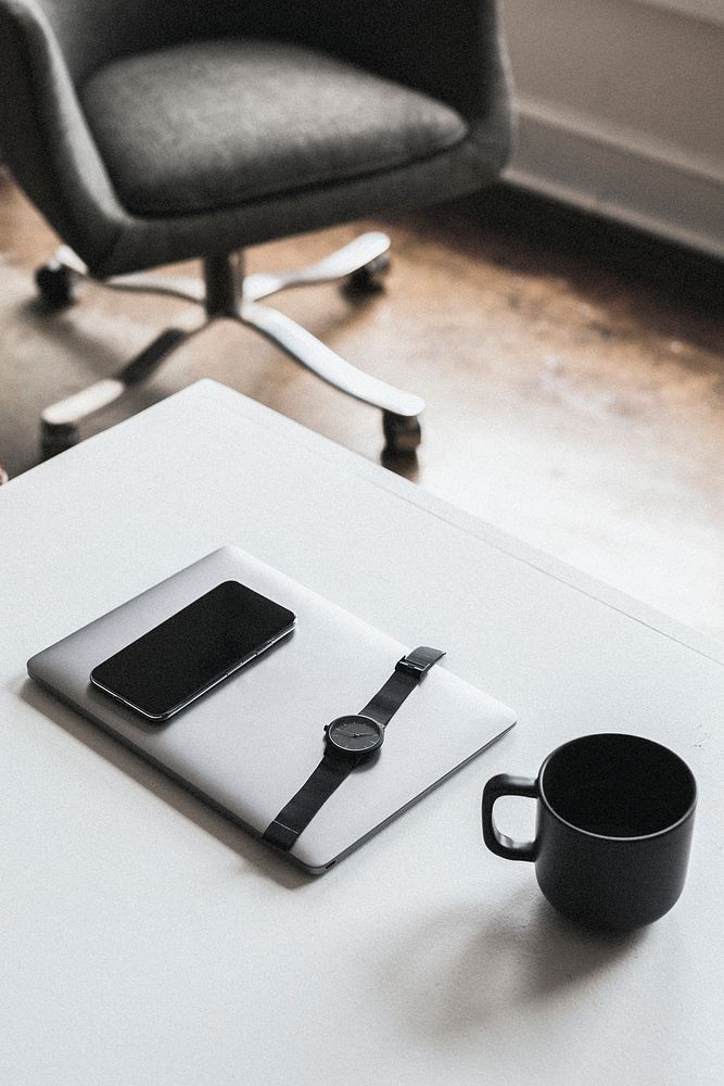 Digital devices by a coffee mug on a desk