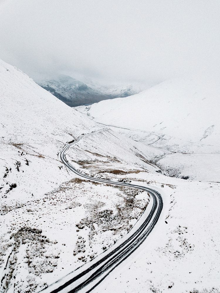 Drone shot of a snowy route of Newlands Pass at the Lake District, England