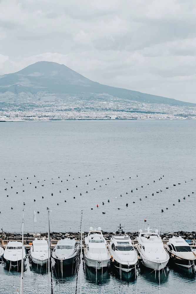 Boats docked at a pier in Naples, Italy