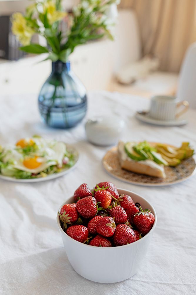 Fresh strawberries with healthy brunch on a dining table