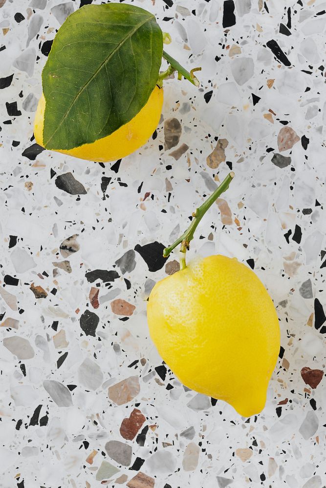 Fresh and organic lemons on a marble chopping board flatlay