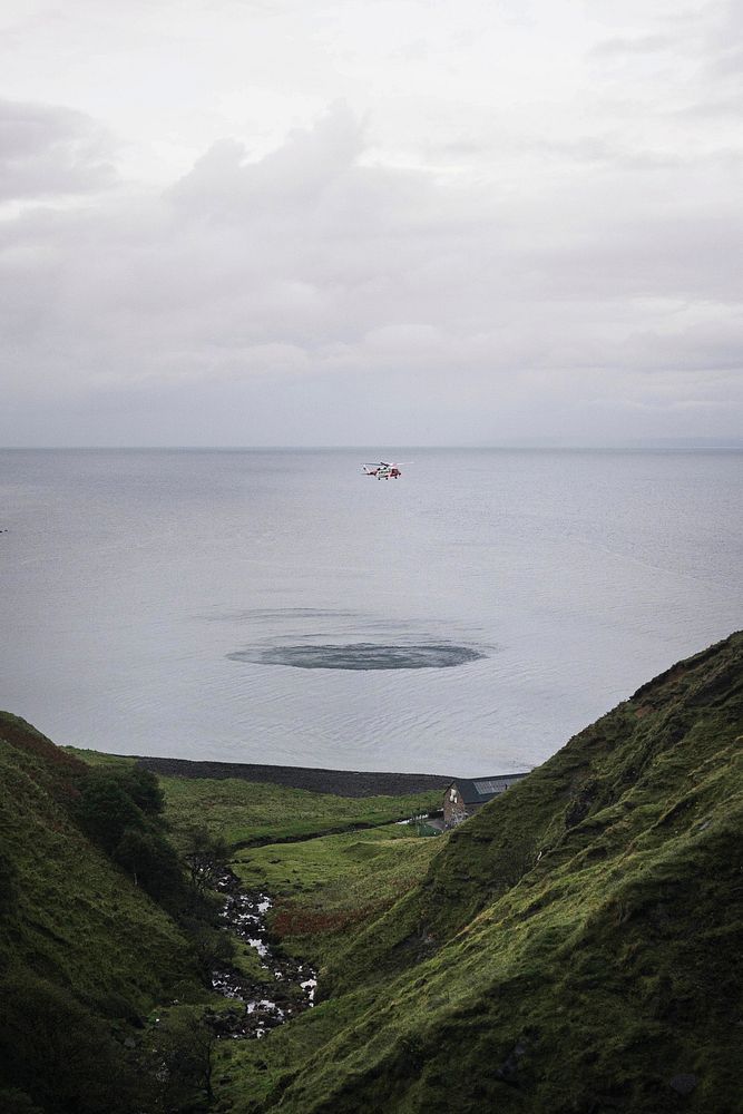 Coastguard helicopter flying over the sea in Scotland