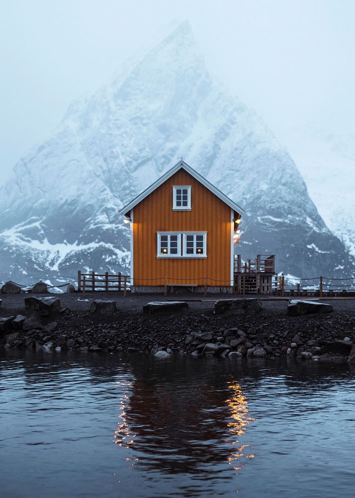 Yellow cabin in Sakrisoy overlooking Mount Olstind in Norway