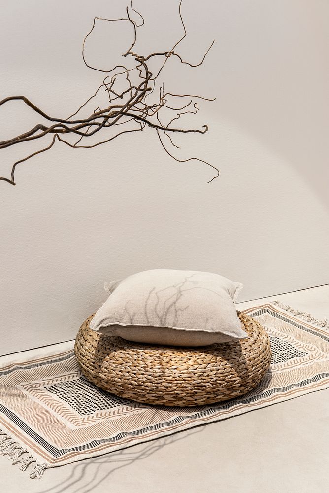 Beige printed cushion on rattan stool interior design