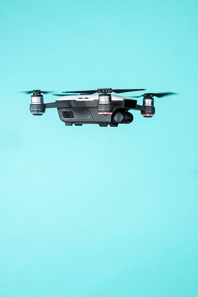 Flying drone isolated on blue background
