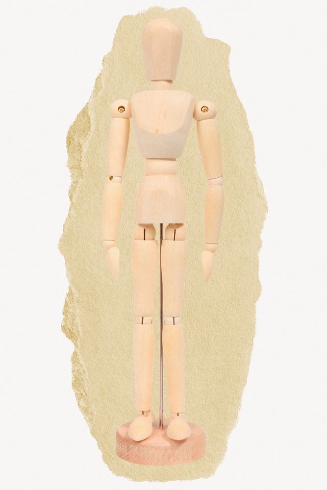 Wooden figure, toy on ripped paper