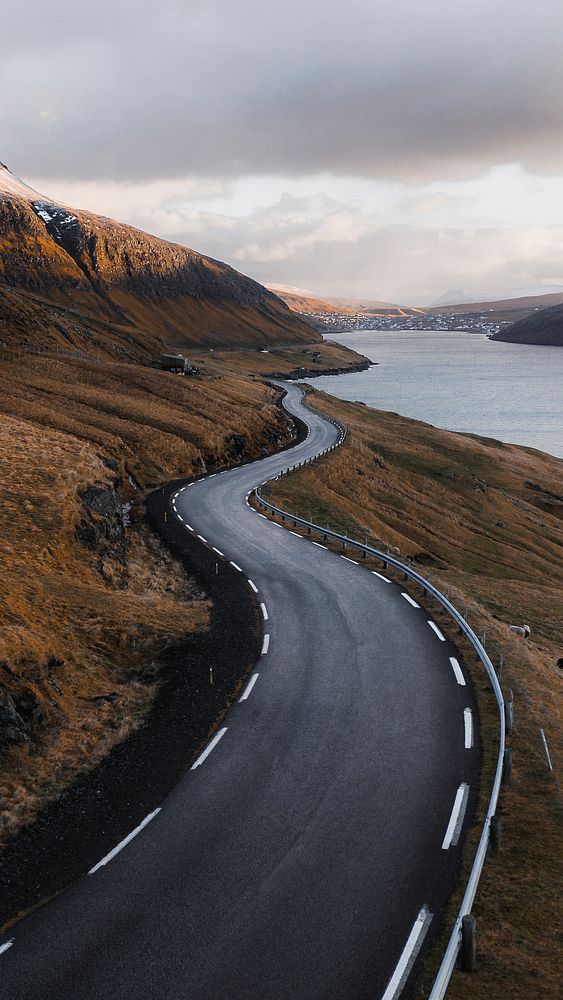 Road mobile wallpaper background, scenic freeway by the lake on Faroe Islands