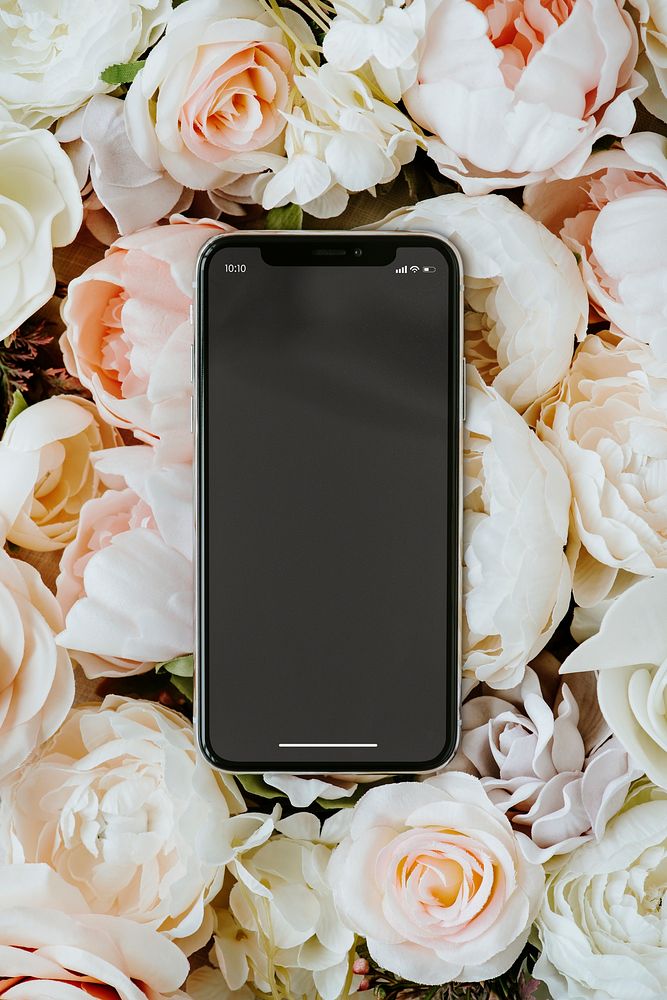 Blank black phone on pastel roses