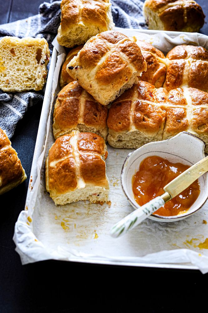 Freshly baked hot cross buns with apricot jam 