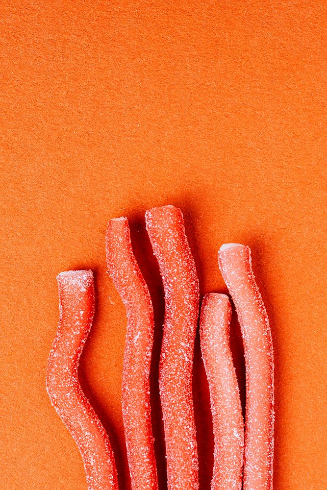 Red chewy candies coated with sugar