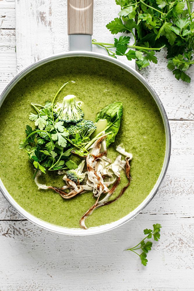 Homemade broccoli soup with horseradish and parsley chips