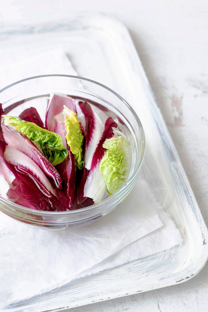 Fresh organic red chicory and green salad in a glass bowl