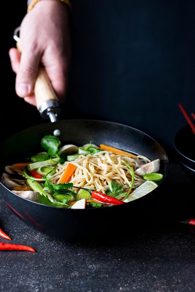 Authentic Asian noodle soup in a black bowl
