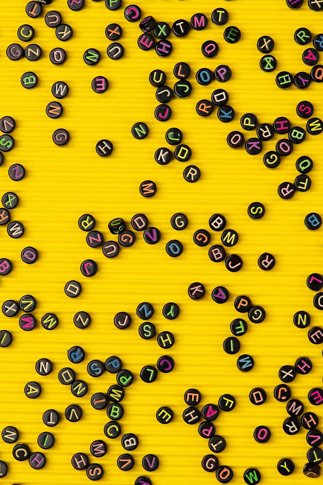 Black letter beads yellow background