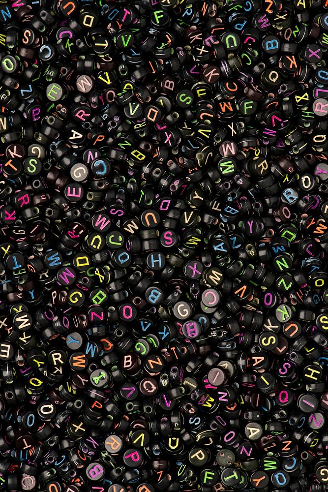 Black English alphabet beads background