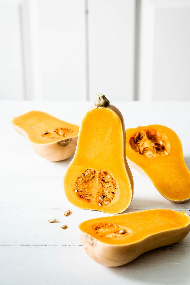 Fresh butternut squash with seeds on white table