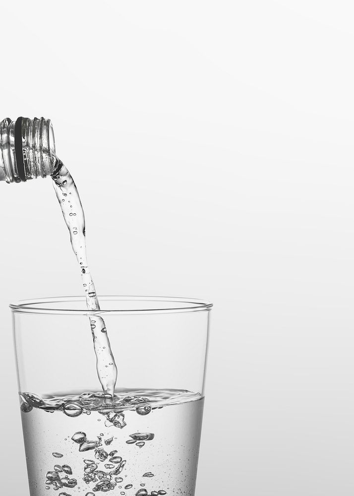 Macro shot of water pouring into a glass