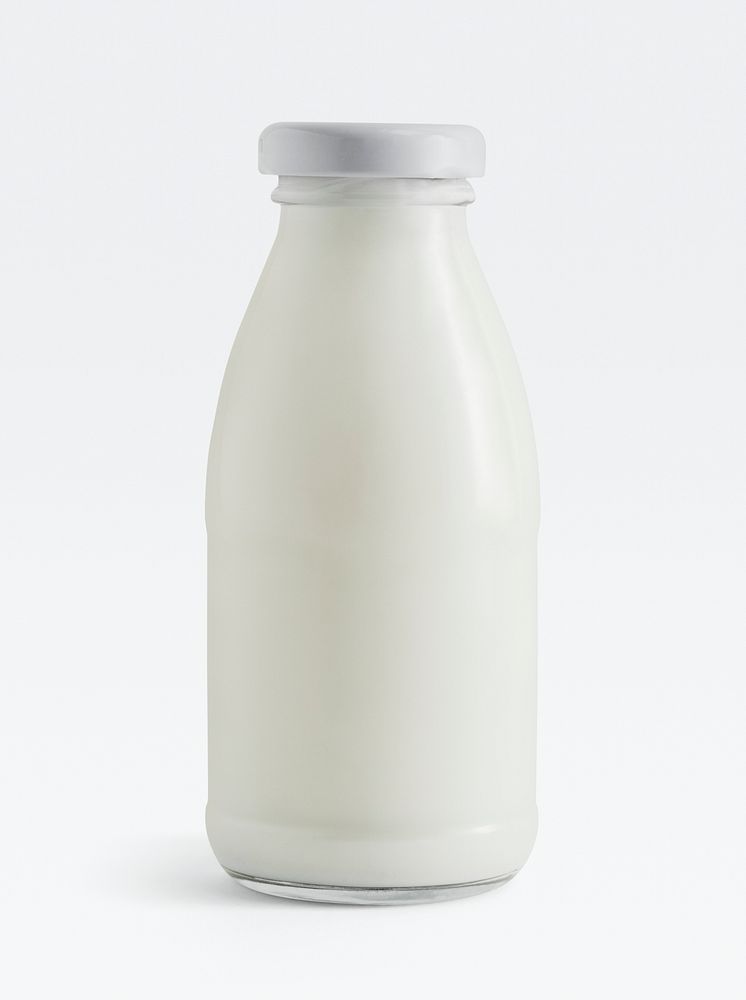 Fresh milk in a glass bottle on white background