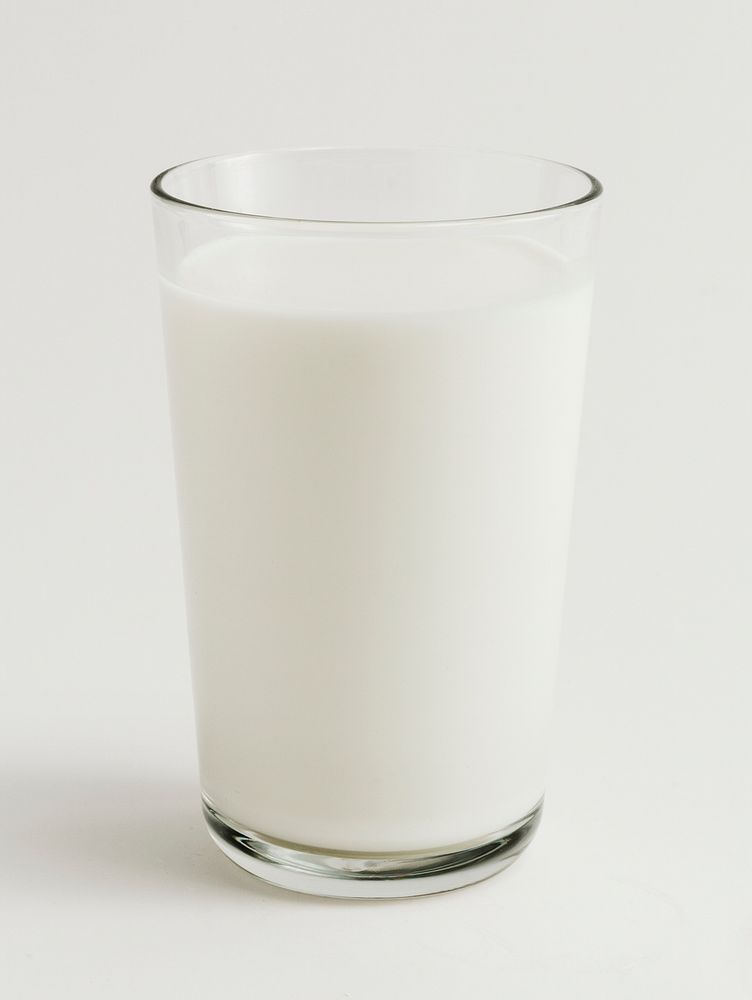 Fresh milk in a glass on white background