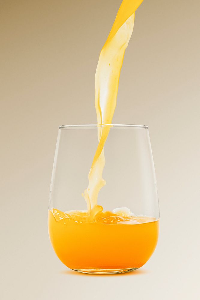 Pouring fresh organic orange juice to a glass