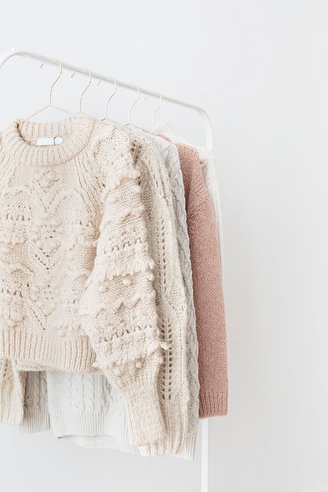 Casual knitted sweaters hanging on a rack