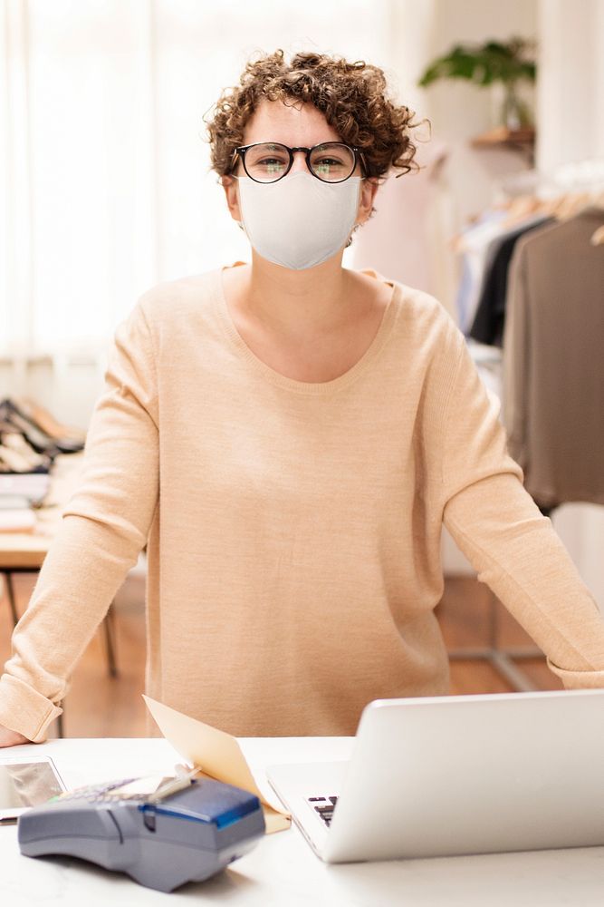 Cashier in mask at a clothing shop