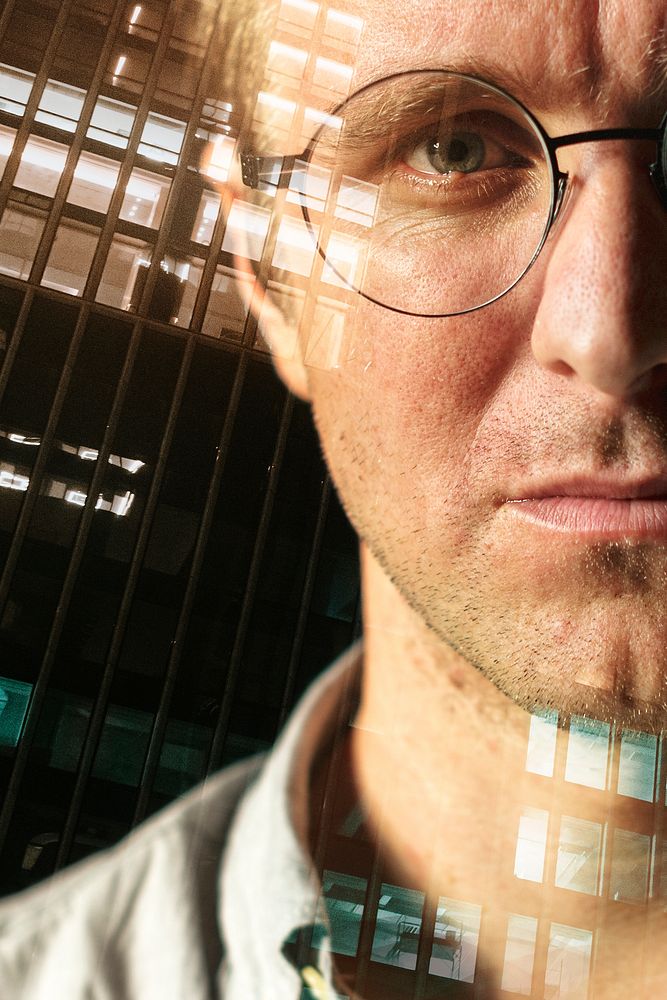 Businessman portrait on city background