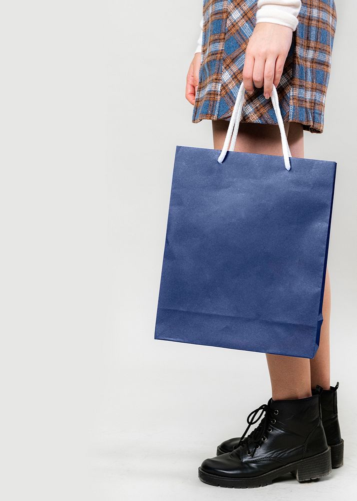 Woman carrying a blue shopping bag