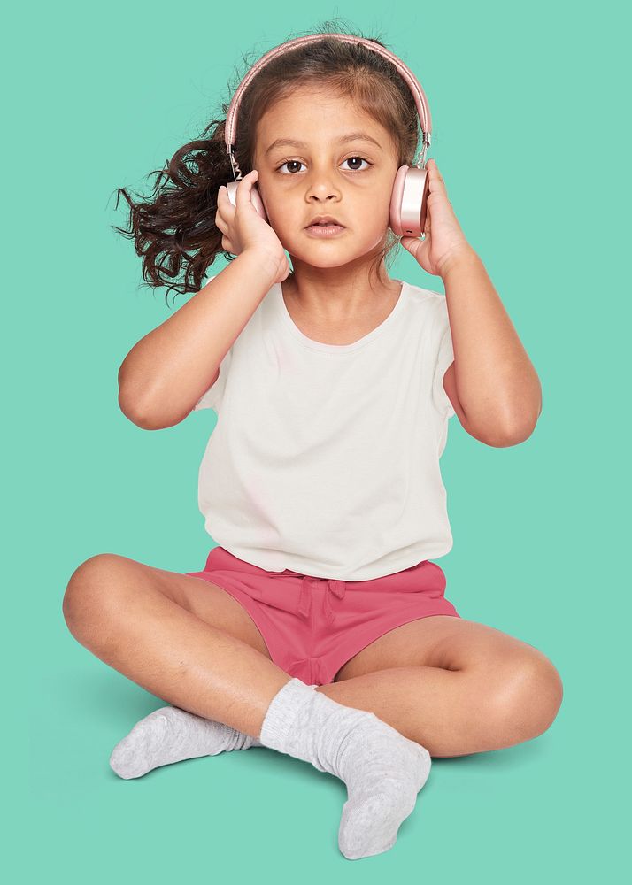 Little girl listening to music on her headphones