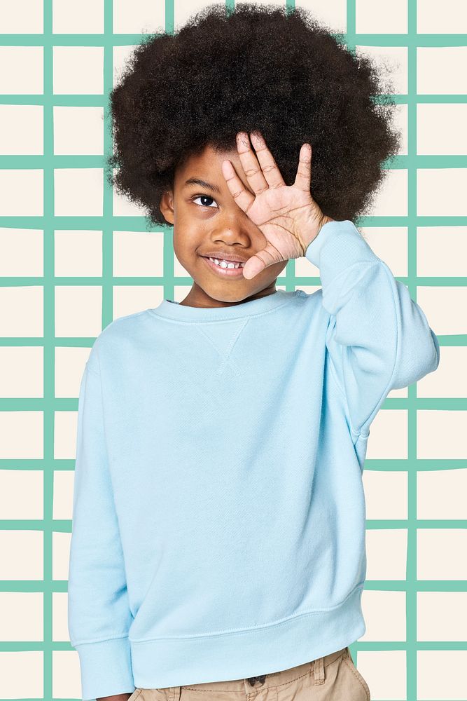 Black boy wearing blue sweater in studio