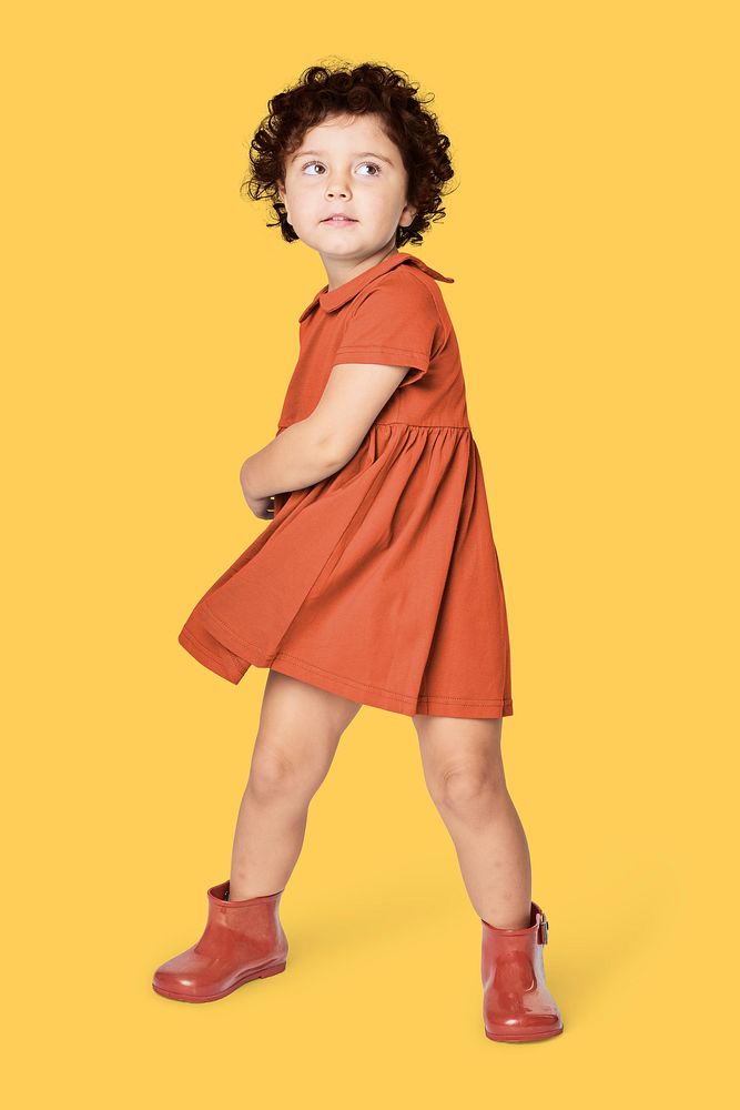 Full body girl wearing orange dress in studio