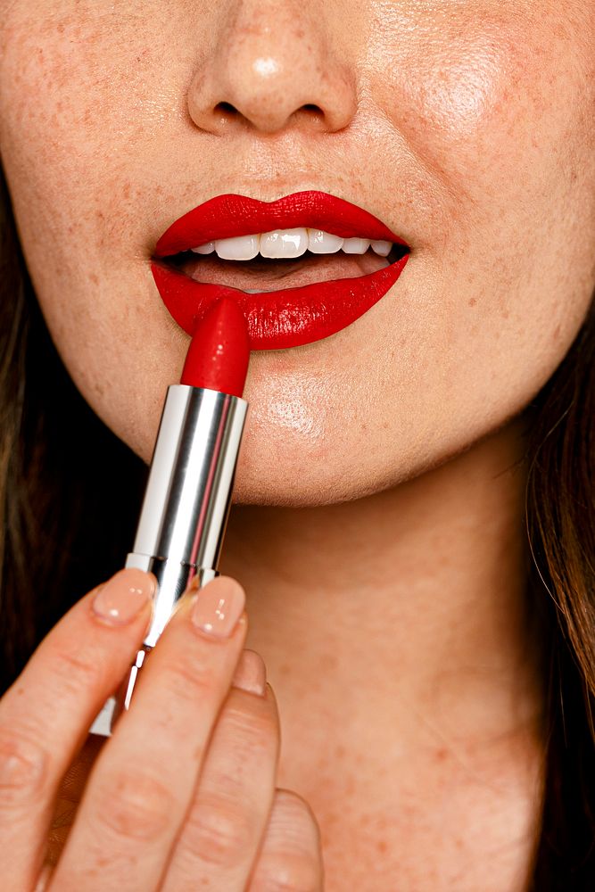 Woman putting on red lipstick, cosmetic & beauty