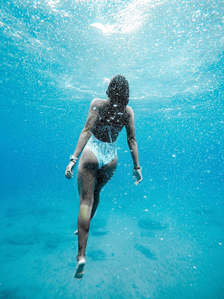 Woman swimming under water. Original public domain image from Wikimedia Commons